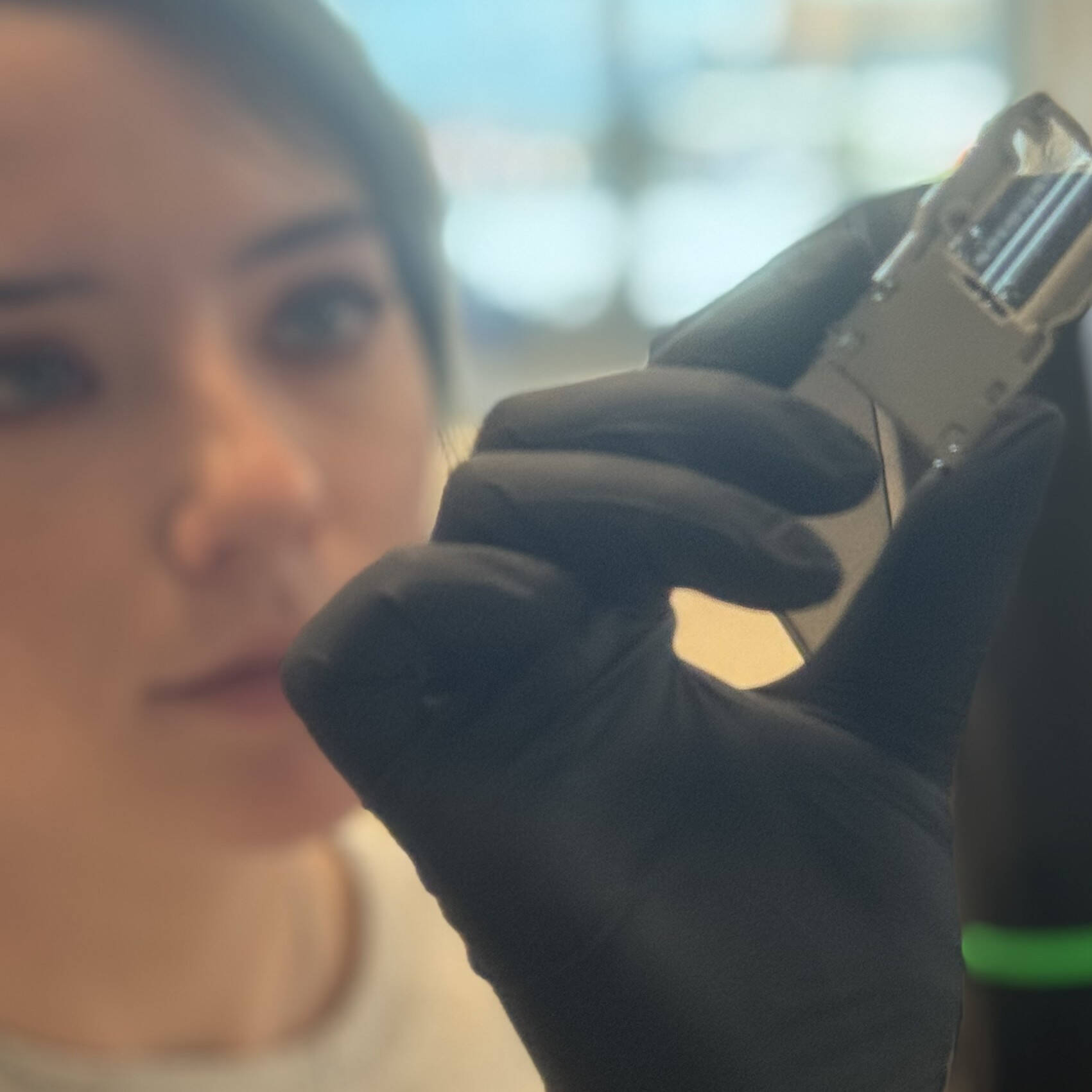 An AWRI researcher holds up a flow cell for inspection.